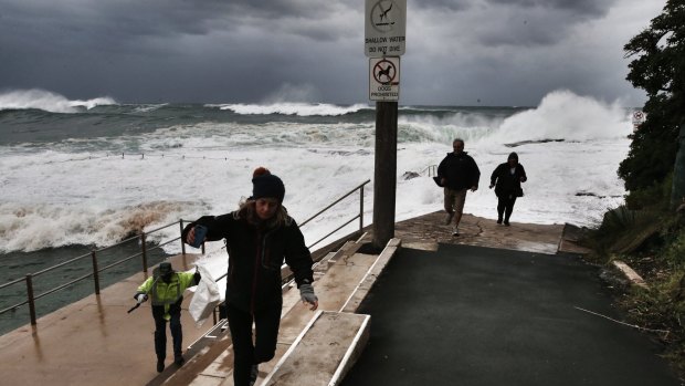 Visitors flee waves at Dee Why.