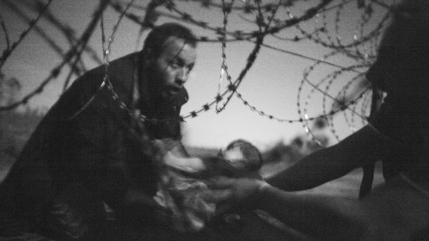 'Hope for a new Life' shows a man passing a baby through a fence at the Serbia-Hungary border in Roszke, Hungary, on August 28, 2015.