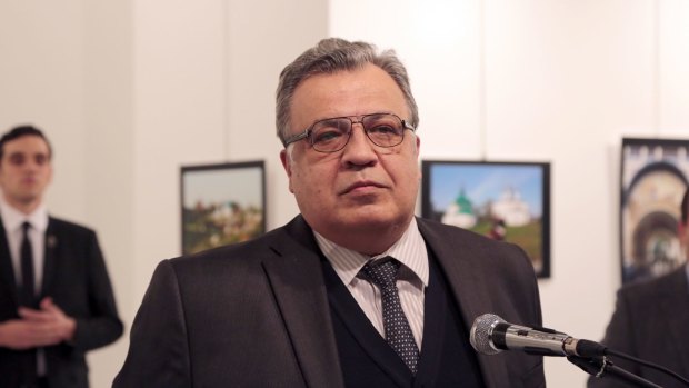 Russian Ambassador to Turkey Andrei Karlov makes an address at the gallery moments before he is shot by Mevlut Mert Altintas, seen in the background.