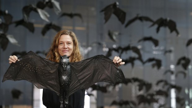 Artist Kathy Holowko and her installation artwork Batmania at Federation Square.