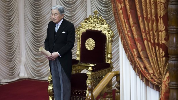 Japanese Emperor Akihito stands in front of the chrysanthemum throne at the opening of parliament on Friday.