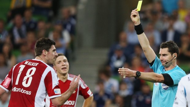 Bradley Walker of Hume City reacts after receiving a yellow card following a contest with Besart Berisha which led to a penalty.