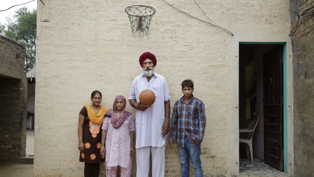 Some of Satnam Singh Bhamara's family, including, from left: his sister, Sarabjot Kaur; mother, Sukhwinder Kaur; father, Balbir Singh Bamrah, who is well over two metres tall; and brother, Beant Singh, at their house in Ballo Ke, India.