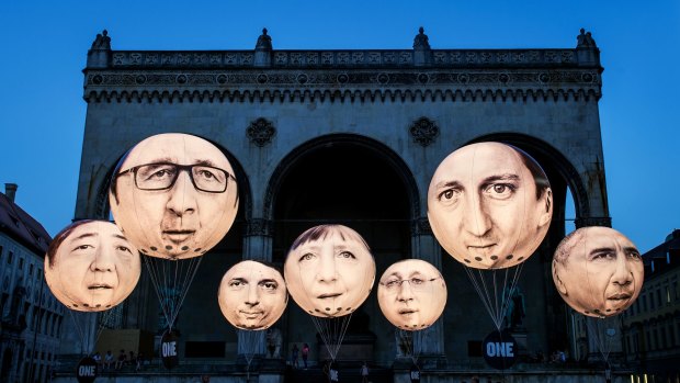 Activists installed balloons decorated with the portraits of (L-R) Japanese Prime Minister Shinzo Abe, French President Francois Hollande, Italian Prime Minister Matteo Renzi, German Chancellor Angela Merkel, Canadian Prime Minister Stephen Harper, British Prime Minister David Cameron and US President Barack Obama during a protest against the G7 summit in Germany.