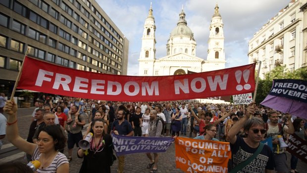 Members of the Migration Solidarity Group of Hungary demonstrate in front of St. Stephen's Basilica in Budapest against the anti-migrant fence.