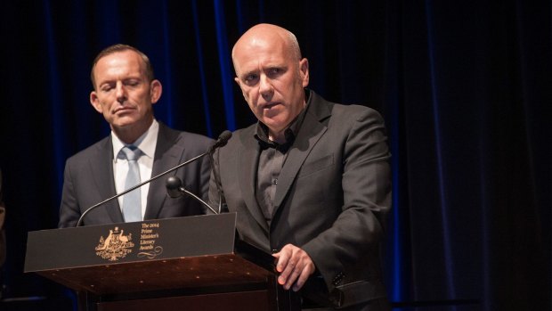 Prime Minister Tony Abbott, pictured in 2014, presenting Richard Flanagan with an award for The Narrow Road to the Deep North.