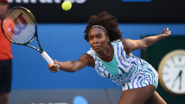 Venus Williams stretches to effect a return against Agnieszka Radwanska.