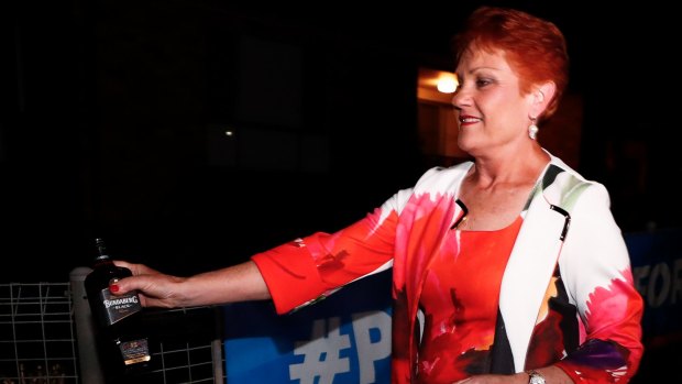 Pauline Hanson departs with a bottle of Bundaberg Rum.
