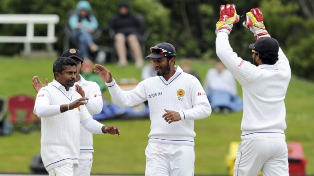 Sri Lanka's Rangana Herath (left) celebrates with his teammates after dismissing Martin Guptill for 46.