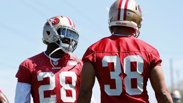 Mentor: Carlos Hyde speaks with Jarryd Hayne during pre-season training last year. 