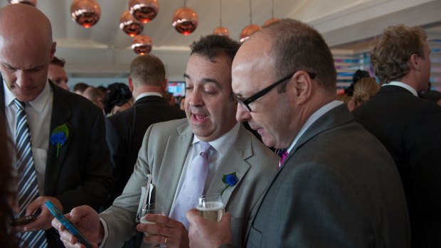 Martin Pakula (centre) inside the Tabcorp marquee during Victoria Derby Day at Flemington in November last year.