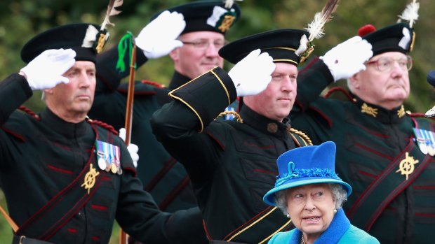 Her majesty ... Queen Elizabeth II walks past ceremonial archers in Tweedbank, Scotland. 