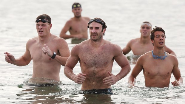 Water torture: Jobe Watson (centre) and Brendan Goddard (left) lead the Bombers to dry land.