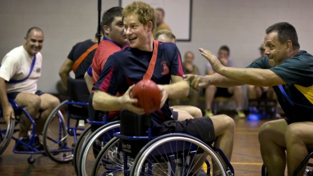 Prince Harry plays wheelchair AFL with wounded soldiers in Darwin.