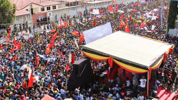 At least 10,000 people gathered outside the Australian embassy in Dili, the capital of East Timor, on Tuesday to protest against Australia's stance on the oil and gas meridian line in the Timor Sea.