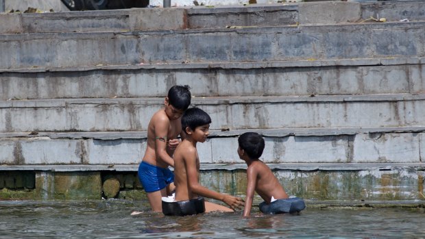 Children play in the waters of Lake Pichola.