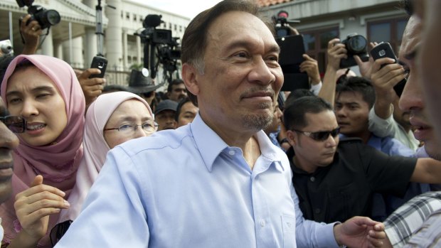 Anwar Ibrahim and his daughter Nurul (left) outside court in 2012 following an earlier acquittal over sodomy charges. 