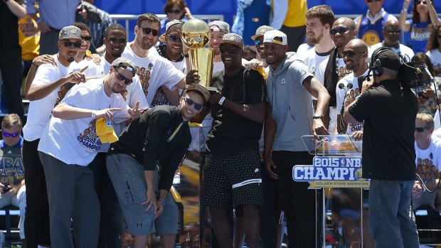 Champions: The Golden State Warriors celebrate with the Larry O'Brien Trophy at The Henry J. Kaiser Convention Center during thier Victory Parade and Rally in Oakland, California.   