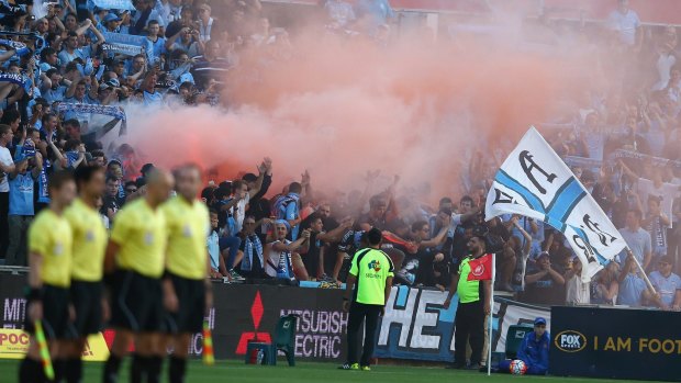 Smokescreen: Sydney FC supporters set off a flare before play in the round 15 A-League match between the Western Sydney Wanderers and Sydney United at Pirtek Stadium.