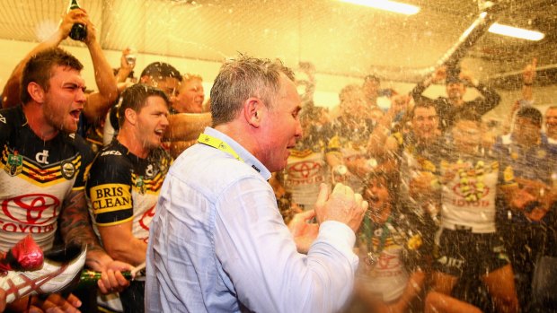 Victory shower: Cowboys coach Paul Green is sprayed by his players with champagne.