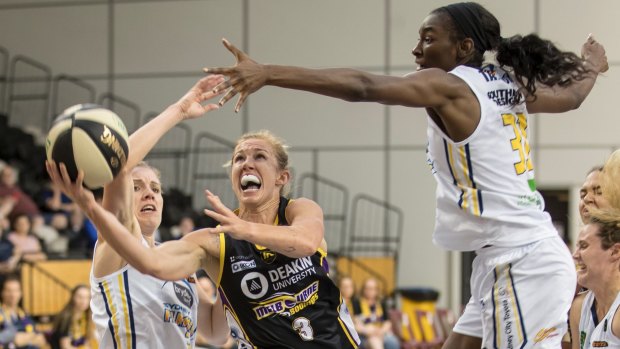 Through ball: Brittany Smart goes under Hayley Moffatt and Asia Taylor to score for the Boomers.