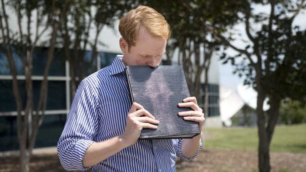 WDBJ7 news anchor Chris Hurst is overcome with emotion while holding a photo album created by his fellow reporter and girlfriend Alison Parker.