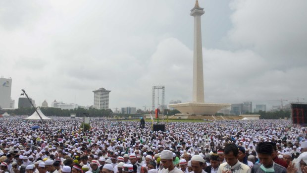 Tens of thousands take part in a prayer at Jakarta's National Monument during the December 2 rally against Ahok.