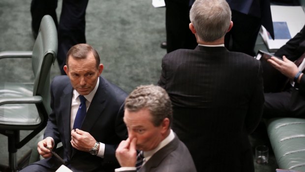 Malcolm Turnbull passes Prime Minister Tony Abbott and Christopher Pyne on Wednesday.