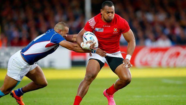 Tongan winger David Halaifonua makes a break despite the attentions of Namibia's Russell Van Wyk.