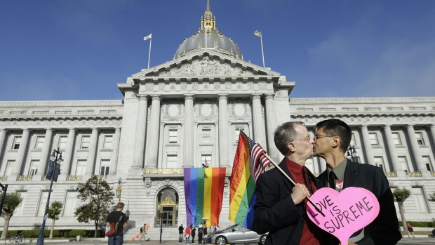Gay rights advocates John Lewis, left, and his spouse Stuart Gaffney, with the group Marriage Equality USA, kiss in San Francisco last month. 
