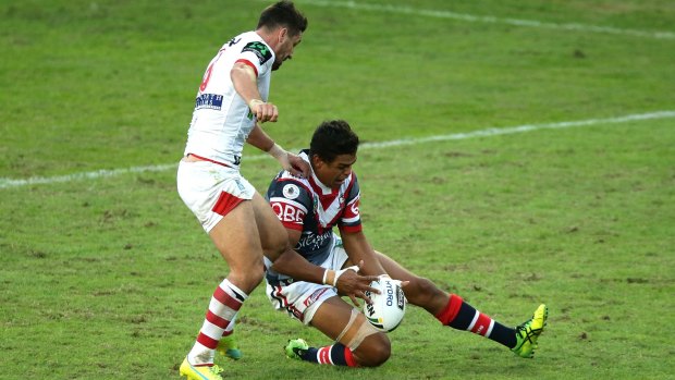 Oops: Gareth Widdop kicks the ball ahead to score a try after a fumble by Latrell Mitchell.