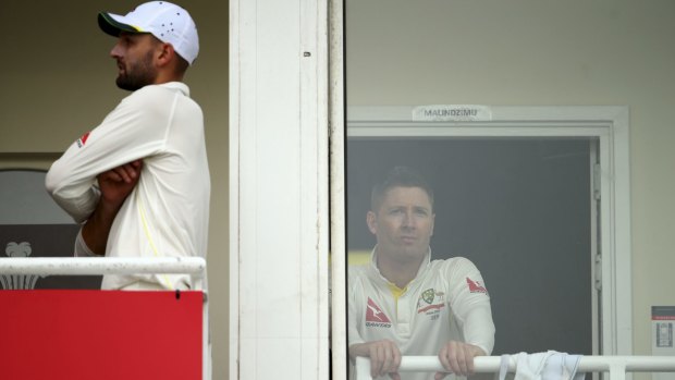 Nathan Lyon and Michael Clarke of Australia look on from the change rooms after rain stopped play.