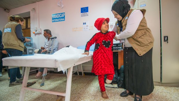 Nada at the EU-funded Muharabeen centre in east Mosul. Her father Adel is treated nearby. 
