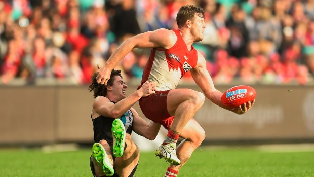 Looking for support: Luke Parker is tackled by Darcy Byrne-Jones during the round 20 AFL match between the Sydney Swans and the Port Adelaide Power at Sydney Cricket Ground.