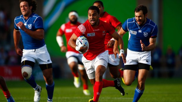 Tonga's Telusa Veainu makes a break against Namibia at Sandy Park in Exeter, United Kingdom.  