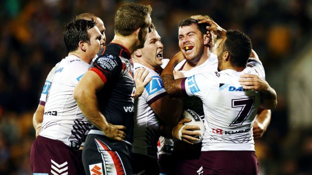 Eagles rock:  Manly's Josh Starling is congratulated by his teammates after he scored a try in the 34-18 win over the Warriors.