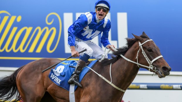 Top of the world: Hugh Bowman celebrates Winx's second Cox Plate win at Moonee Valley.