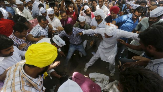 Shocked protesters gather round the body of the farmer during the rally in New Delhi. 