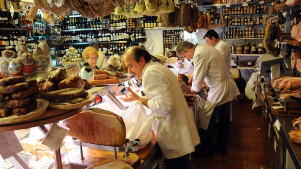 Customers are served at Volpetti delicatessen in the Testaccio suburb of Rome.