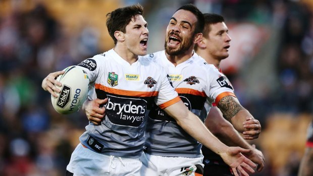 Tigerish spirit: Mitchell Moses celebrates with teammate Dene Halatau after scoring a try during the round 25 NRL match between the New Zealand Warriors and the Wests Tigers at Mount Smart Stadium.