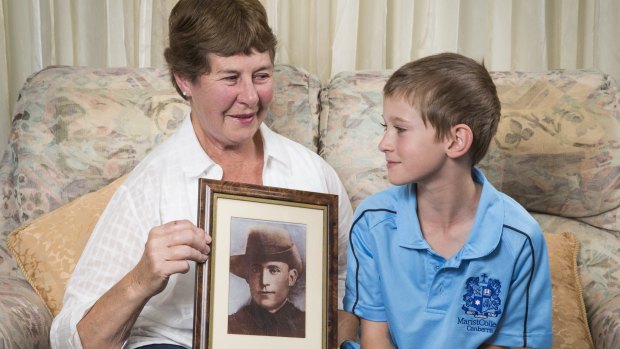 Maureen Blackmore and her grandson Nic Blackmore, 9, with a photo of her grandfather Thomas Johnson from Gallipoli and France during WWI. 
