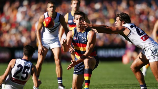 Taylor Walker of the Crows passes the ball.