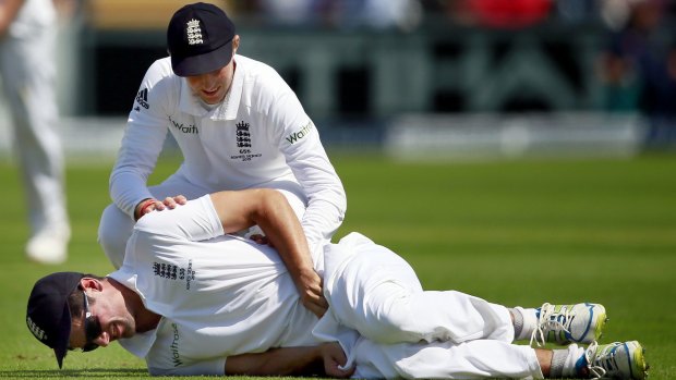 England captain Alastair Cook is consoled by vice-captain Joe Root after being struck in the groin by the ball.