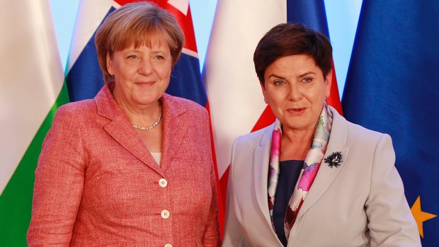 German Chancellor Angela Merkel, left, is greeted by Poland's Prime Minister Beata Szydlo in Warsaw last month during talks with four European leaders about Brexit leaves and migrants.