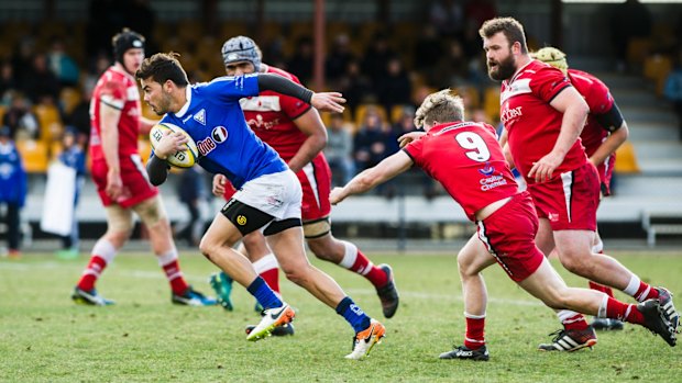 Andrew Muirhead breaks the Tuggeranong Vikings defence.