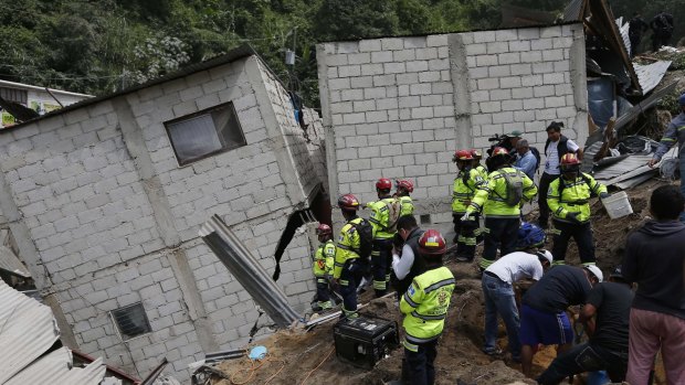 Rescue workers respond after a mudslide on the outskirts of Guatemala City. Heavy rain provoked a hillside to collapse, burying dozens of homes. 