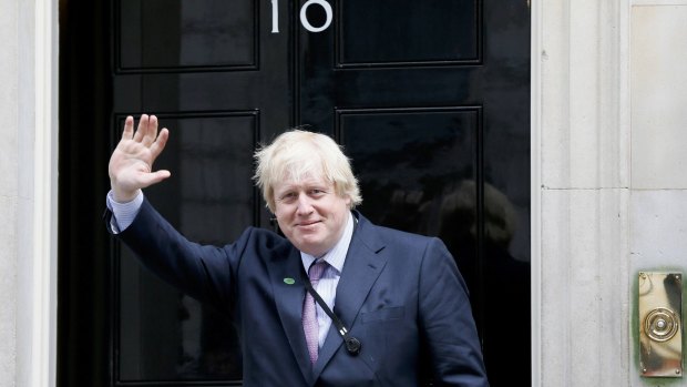 Boris Johnson waves as he arrives at 10 Downing Street as Britain's re-elected Prime Minister David Cameron names his new cabinet.