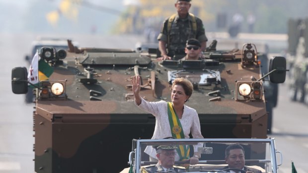 Brazilian President Dilma Rousseff waves from an open car during military celebrations marking Brazil Independence Day, in Brasilia, on Monday.