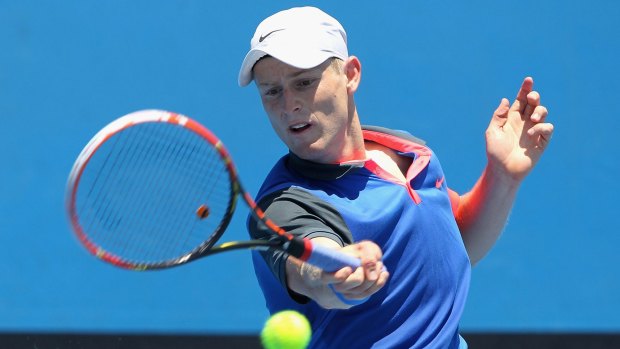 Luke Saville plays a forehand against Christopher O'Connell during the Australian Open wildcard playoffs.