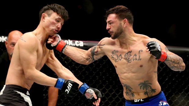 On the button: Cub Swanson, right, lands a punch against fellow featherweight Doo Ho Choi.